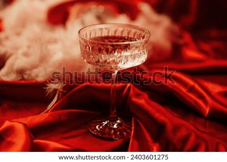 Extravagant bedroom luxury interior with love glamur decoration at Valentine day in studio. Balloons by heart shaped and at illuminated mirror romantic cozy atmosphere at vivid red background.  Royalty-Free Stock Photo #2403601275
