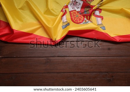 Flag of Spain on wooden background, top view. Space for text