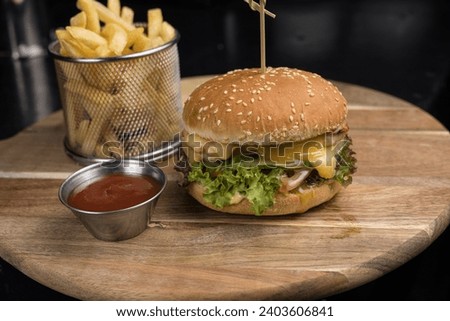 delicious hamburger with cheese, greens and cutlet