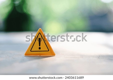 close up caution sign on wood table, planning and manage to success business concept