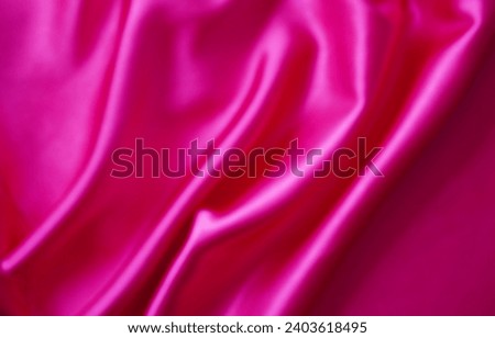 Pink silk or satin background, wavy, elegant and elegant. Close-up, background. Space for designblur or blurry 