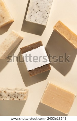 Beige and brown soap bars on light beige ctop view hard shadows, packaging mockup, copy space. Natural herbal products for face and body care. Organic handmade skincare products
 Royalty-Free Stock Photo #2403618543