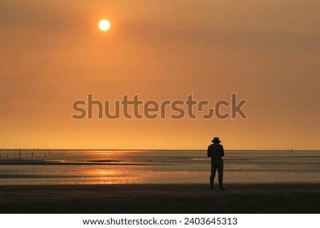 A man was hunting photo on beach