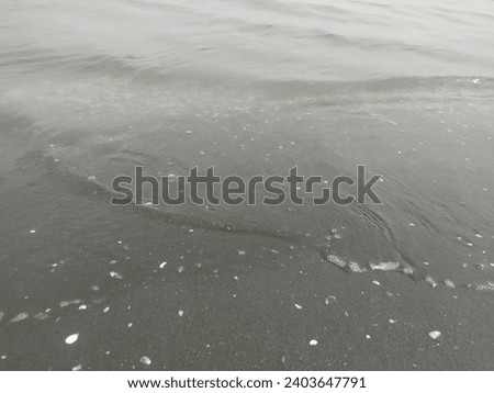 small waves of murky sea water
