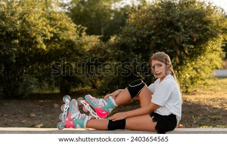Portrait of a girl on roller skates in the park with sun rays in the background. Copy space