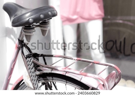 Antique pink bicycle pillion, background with mannequin in pink dress, fashion Royalty-Free Stock Photo #2403660829