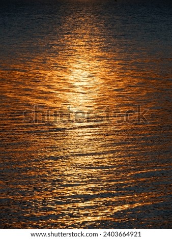 golden hour, golden track of sunlight along the sea water