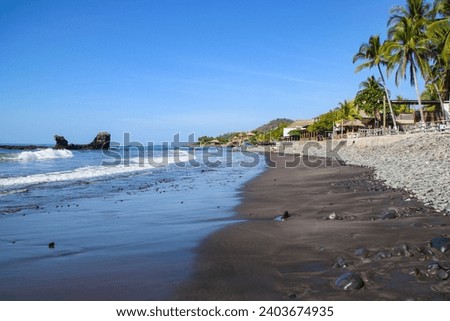 Black sand volcanic beach in the Pacific Ocean in El Salvador.