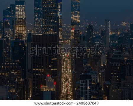 A high angle aerial view from over Long Island City on a cloudy night. High over the tall residential buildings in Queens, NY showing the New York City skyline.