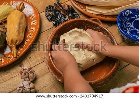 Person kneading nixtamalized corn dough to prepare tamales. Typical Mexican food.