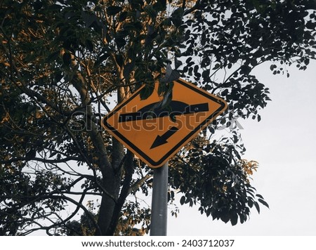 Speed Bump Sign - Brazil - Traffic sign indicating speed bump on street with trees in the background