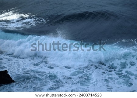 Ocean waves crashing on the beach in a sunny morning, dramatic blue sky on a beautiful beach