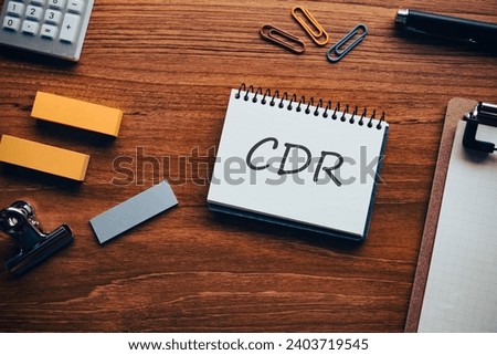 There is notebook with the word CDR. It is as an eye-catching image. Royalty-Free Stock Photo #2403719545