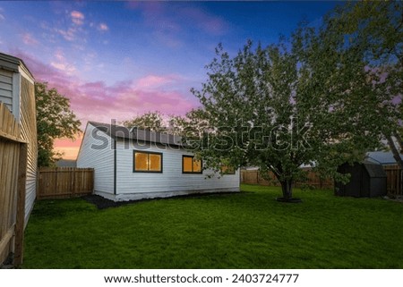 a back yard at sunset  Royalty-Free Stock Photo #2403724777