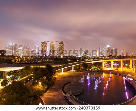 Tracel background of Singapore skyline illumintaed in the evening twilight Royalty-Free Stock Photo #240373159