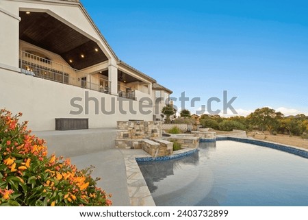 a home swimming pool with a patio 