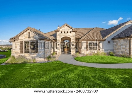The front view of a home with a yard  Royalty-Free Stock Photo #2403732909
