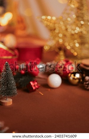 
vertical background for christmas with tree and toys and shiny red golden ribbon in glitter  in cozy and warm bokeh lights for holiday vibes