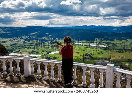 Young woman at a viewpoint over the beautiful Sopo valley at the department of Cundinamarca in Colombia