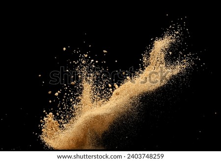 Big size Sand flying explosion, Golden grain wave explode. Abstract cloud fly. Yellow colored sand splash throwing in Air. Black background Isolated selective focus blur Royalty-Free Stock Photo #2403748259