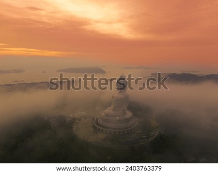 
Colorful first light of the morning covered with mist. Phuket Big Buddha view point
The sun shines on the mist shroud above Phuket Big Buddha. I could see the Buddha image faintly. The sun shines