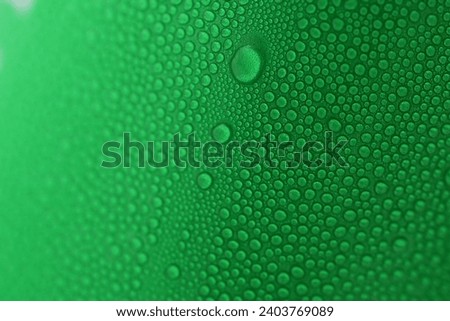 water drop on green beverage cans background, texture of cold aluminium package
