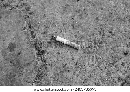 Close up Cigarette. A lot of cigarette butts and matches are lying on the road. Trash