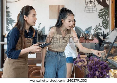 Asia woman owner happy and smile receive order from customer. guarantees safety, cleanliness, open the coffee shop. open for New normal. Small business, welcome, restaurant, home made, cafe