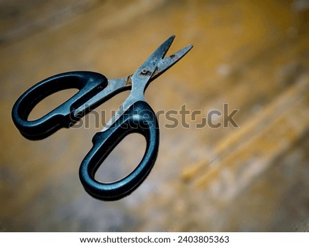 black scissors, scissors with black handle and blur background