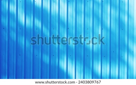 Blue color corrugated metal zinc sheet texture background with sunlight for design art work and pattern, wallpaper, Close up. Royalty-Free Stock Photo #2403809767