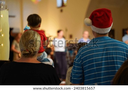 Christmas Harmony A Couple Observes a Festive Church Carol Service Embracing the Seasonal Joy from Behind in a Heartwarming Scene