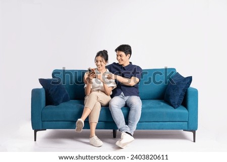 Image of an Asian couple posing on a white background Royalty-Free Stock Photo #2403820611
