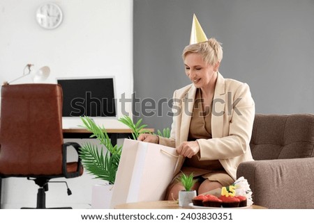 Mature woman celebrating her Birthday in office