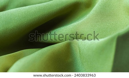 Close-up of trendy green fabric texture. Abstract background.