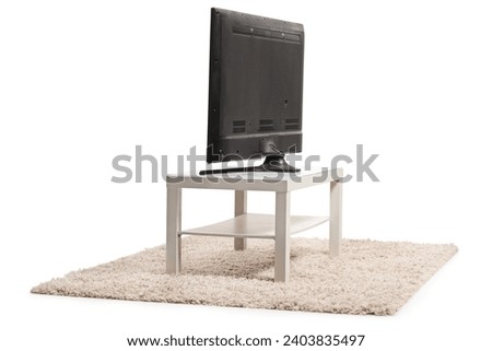 Rear view shot of a tv on a white table isolated on white background Royalty-Free Stock Photo #2403835497