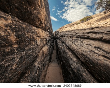 Close up of small narrow passage with steps between stones in canyonlands national park in Utah, America, usa Royalty-Free Stock Photo #2403848689