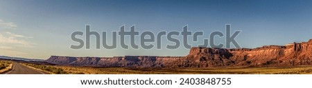 Panorama shot of long orange sandy massif of rock and road to canyonlands in utah, america, usa Royalty-Free Stock Photo #2403848755