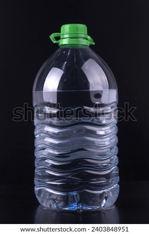 A plastic bottle with filtered water in the dark