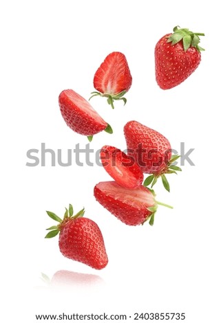 Fresh ripe strawberries falling on white background Royalty-Free Stock Photo #2403855735