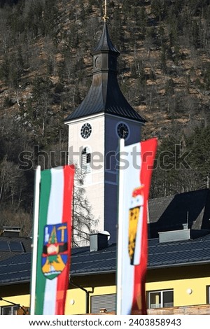 Community flag and state flag in front of the parish church in Ebensee (Gmunden district, Salzkammergut)