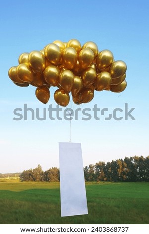 Flying Gloden Metallic Colored Balloon With Blank White Space  for Mockup Occasional Celebration Notes. Dies Natalies, Anniversary, Party, Tradition. Royalty-Free Stock Photo #2403868737