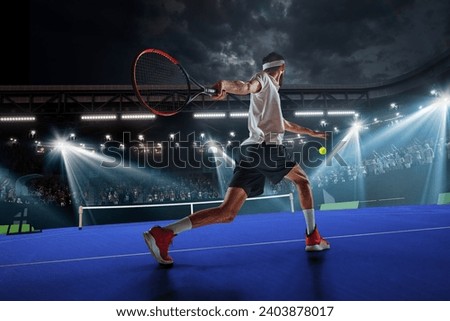 Dynamic image of young man, tennis player in motion during game, hitting ball with racket. 3D arena. Tennis court and fan zone. Concept of sport, competition, tournament, action, success Royalty-Free Stock Photo #2403878017