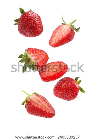 Fresh ripe strawberries falling on white background