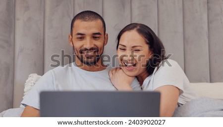 Laptop, happy and young couple in bed watching movie, film or show together at home. Smile, technology and man and woman relaxing in bedroom streaming a video on computer for bonding at modern house.