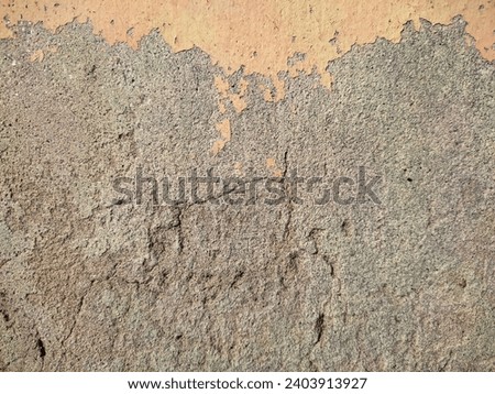 Cracked cement wall texture background. Blank empty Cracked cement wall surface. Landscape photo. The color has come off the cement wall.