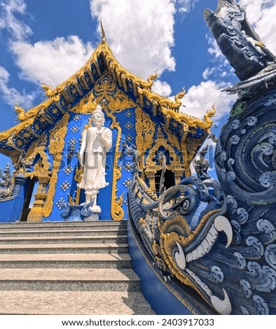 Large Buddha statue on facade of Blue Temple (Thai: Wat Rong Suea Ten) at Chiang Rai Thailand