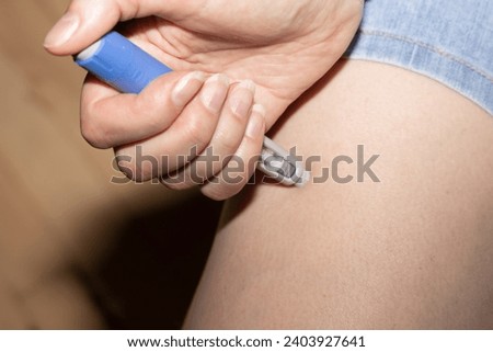 Female hands holding an insulin pen. Ozempic Insulin injection pen or insulin cartridge pen for diabetics. Medical equipment for diabetes parients Royalty-Free Stock Photo #2403927641