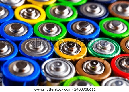 Energy abstract background of colorful batteries.Used batteries from different manufacturers, waste, collection and recycling,Alkaline battery aa size.Concept background of colorful batteries Royalty-Free Stock Photo #2403938611