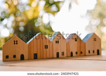 close up wooden house on table, saving and manage money for building, home insurance business technology, subprime mortgage crisis risk and problem concept