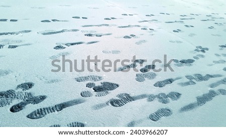 Footprints on the snowy surface. Snow cover with human footprints